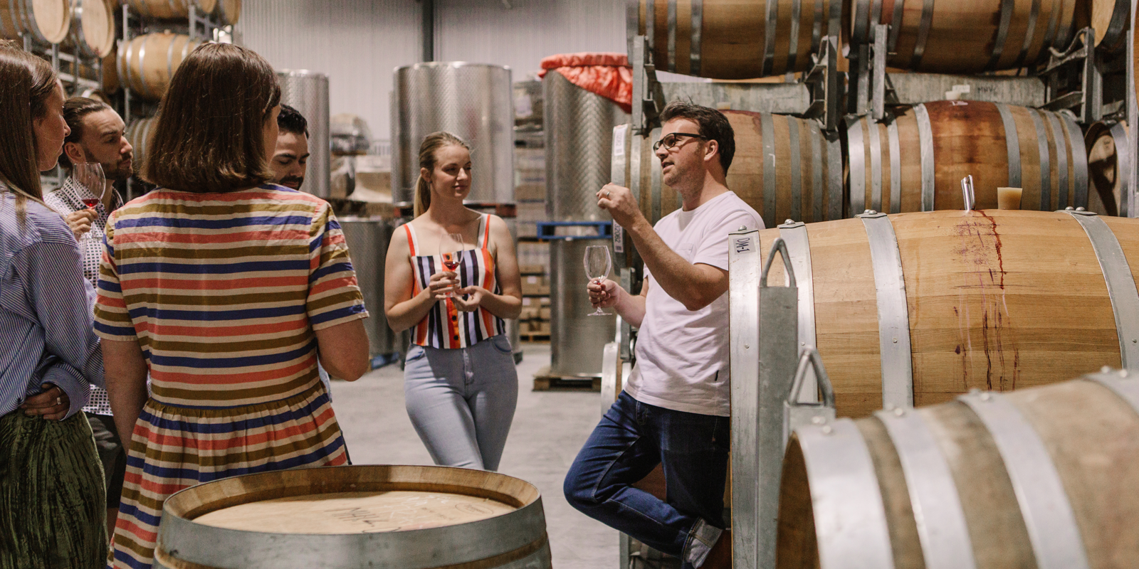 Visitors hearing the Murdoch Hill story in the winery.